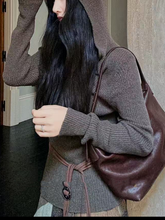 A thin hooded knitted top for women